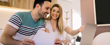 Man and woman looking at finances together on laptop