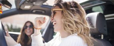 Two women in car smiling and laughing